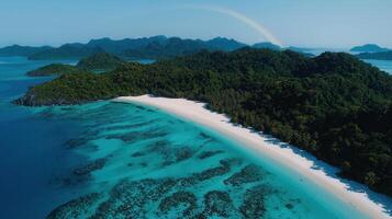 Tropical Island Paradise Pristine White Sand Beach and Turquoise Ocean with Lush Green Foliage and Rainbow photo