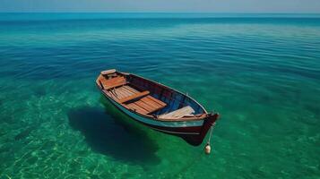 Serene Wooden Rowboat Floating in Crystal Clear Turquoise Water Peaceful Summer Vacation Scene photo