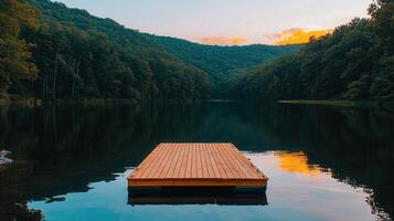 Serene sunset view of a wooden dock floating on a calm lake surrounded by lush green forest hills photo