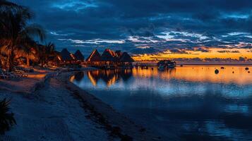 Serene Sunset Over Tropical Beachfront Cabanas Illuminated at Dusk Tranquil Ocean Scene photo