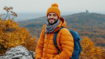 Happy Man Hiking in Autumn Mountain Landscape Wearing Orange Jacket Backpack photo