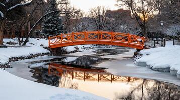 Scenic Winter Landscape Orange Bridge over Frozen River in Snowy Park photo