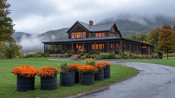 Beautiful Autumnal Farmhouse nestled in the mountains with scenic views and flowering plants photo