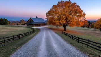 Scenic Autumn Countryside Gravel Road Leading to Rustic Barn and Vibrant Fall Foliage photo