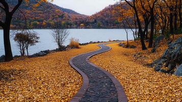 Serene Autumn Path Winding by a Lake Picturesque fall foliage and stone walkway photo