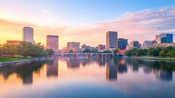 A serene cityscape at sunset reflecting on a river, showcasing urban architecture and nature photo