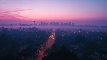 A serene cityscape at dawn with fog and streetlights illuminating the path photo