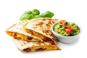 A plate of quesadillas served with guacamole and fresh tomatoes. photo
