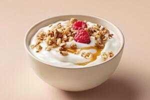 A bowl of yogurt topped with granola, raspberries, and honey photo