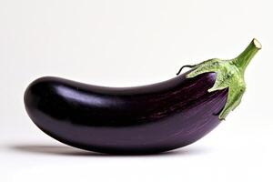A single, glossy eggplant resting on a light background photo