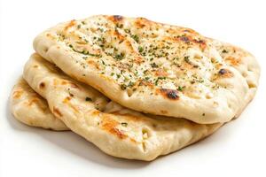 A stack of freshly baked naan bread, garnished with herbs. photo