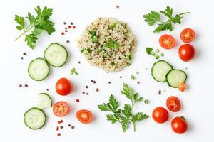 A vibrant arrangement of quinoa, vegetables, and herbs on a white background photo