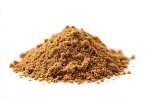 A pile of brown powder on a white background, possibly a spice or seasoning. photo