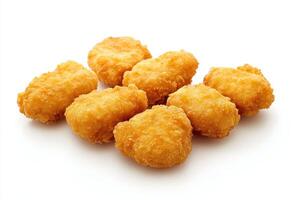 A pile of golden, crispy chicken nuggets on a white background. photo