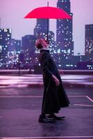 Mysterious Clown Performer with Red Umbrella in Urban Nightscape. photo