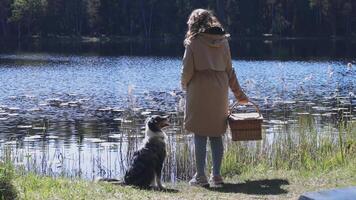 Person and Dog by a Lake with Lily Pads and Dense Trees video