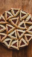 An assortment of triangular shaped cookies on a wooden table photo