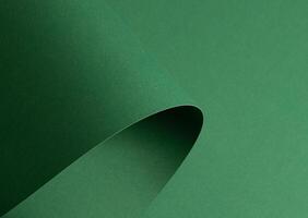 Deep forest green paper background with a smooth texture and elegant folds. Rich emerald and pine photo