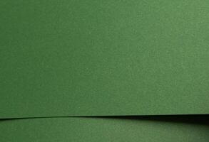 Deep forest green paper background with a smooth matte texture and subtle geometric patterns photo