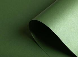 Emerald green paper background with a pearlescent, glossy texture. Deep forest and sage tones create photo