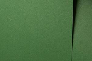 Deep forest green paper background with a smooth matte texture. Rich basil and olive tones create an photo