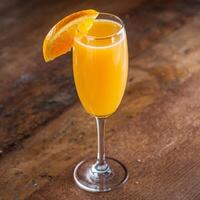 A glass of orange juice on a table photo