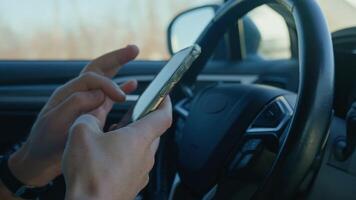 Close-up of driver hands using smartphone while driving car, risk of distraction and road safety concerns. Dangerous driving of vehicle, violation of traffic rules video