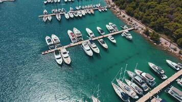 Aerial view of yachts and boats moored in Marina Frapa in Rogoznica, Croatia. Harbor of seaside town in sunny day. Concept of summer holidays and travel video