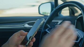 Close-up of driver hands using smartphone while driving car, risk of distraction and road safety concerns. Dangerous driving of vehicle, violation of traffic rules video