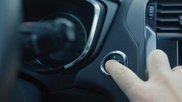 Close-up of finger pressing push start button in modern car to start engine. Keyless ignition system in modern vehicle video