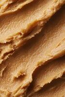Cosmetic brown creamy scrub for face, body or scalp. Texture background. photo