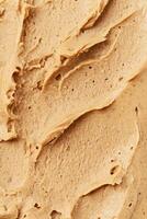 Cosmetic beige and brown creamy scrub for face, body or scalp. Texture background. Almond Mask photo