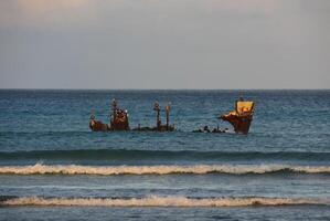 Sun Rising Over a Rusty Wreck of a Shipwreck photo