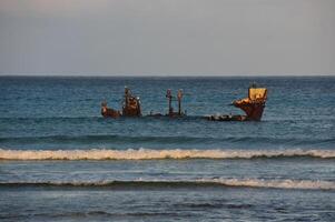Waves Surrounding a Rusted Shipwreck in Aruba photo