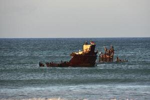 Rusted Remains of a Boat in Shallow Waters photo