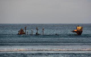 Shallow Ocean Waters with Rusty Shipwreck Remains photo