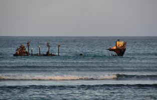 Waves Rolling in Around the Remains of a Shipwreck photo