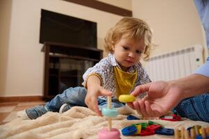 Adorable Toddler Engaged in Stacking Activities While Learning Through Play Indoors photo
