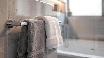 Close-up of Heated Rail with gray Towels in Bathroom with copy space. Modern heated towel rail on wall photo