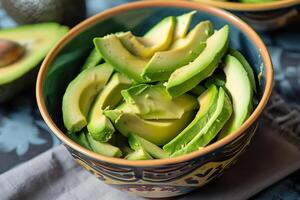 Fresh avocado slices in a bowl, ready to eat. Healthy vegan food, organic ingredient for salads, toast, and guacamole. photo