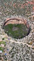 Aerial view capturing limestone landscape with deep, massive cennet and cehennem sinkholes dominating rugged terrain of remote mersin province video