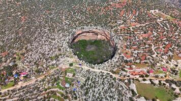 Aerial view capturing limestone landscape with deep, massive cennet and cehennem sinkholes dominating rugged terrain of remote mersin province video