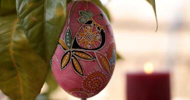 Easter decorations featuring handcrafted Easter egg dot art pysanka with vibrant colors and intricate designs displayed against a warm background photo