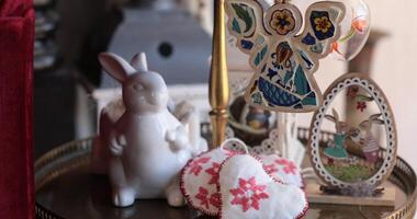 Easter decorations displayed on a table with handcrafted items and a white bunny sculpture creating a festive atmosphere photo