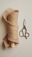A roll of brown twine and scissors on a table photo