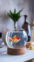 A goldfish is in a bowl on a table photo