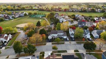 Aerial view of a suburban neighborhood in Illinois, United States, with rows of houses, green fields, and a playground. video