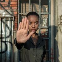 A woman making a stop sign with her hand photo