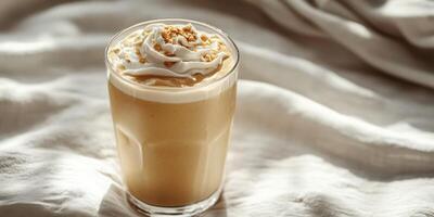 Creamy coffee beverage topped with whipped cream and nuts on a textured surface photo