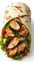 Grilled chicken wrap filled with fresh vegetables and herbs served on a white background photo